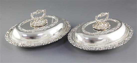 A pair of ornate Victorian oval silver plated entrée dishes with covers, length 278mm.